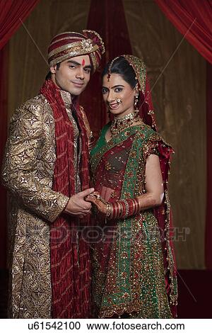 Portrait of young couple holding hands View Large Photo Image Stock Image - Portrait of young couple holding hands . Fotosearch
