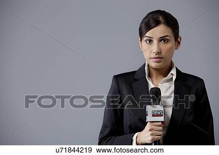 Portrait of young female newscaster against colored background View Large Photo Image Stock Photo - Portrait of young female newscaster against colored background . Fotosearch