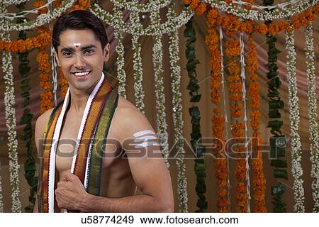 Portrait of young groom wearing traditional Indian clothing View Large Photo Image Stock Photo - Portrait of young groom wearing traditional Indian clothing . Fotosearch