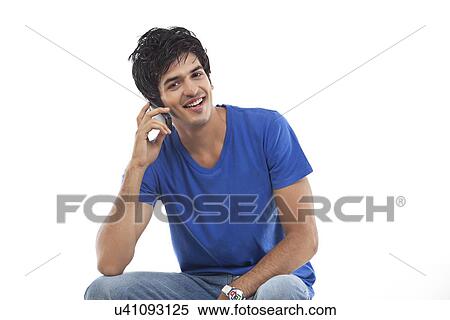 Portrait of young man using mobile phone View Large Photo Image Stock Photography - Portrait of young man using mobile phone . Fotosearch