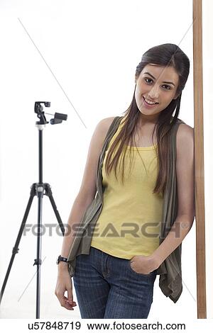 Portrait of young photographer leaning against wall in her studio View Large Photo Image Stock Photo - Portrait of young photographer leaning against wall in her studio . Fotosearch