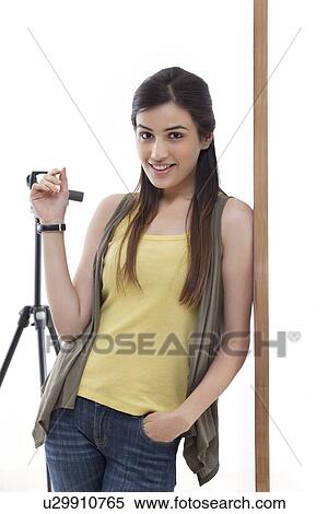 Stock Photography - Portrait of young photographer leaning against wall . Fotosearch