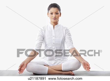 Portrait of young woman doing yoga over white background View Large Photo Image Stock Image - Portrait of young woman doing yoga over white background . Fotosearch