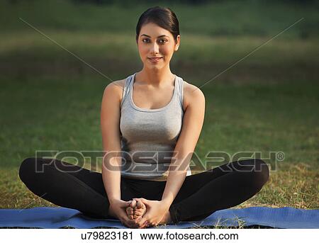 Stock Image - Portrait of young woman doing yoga practice . Fotosearch