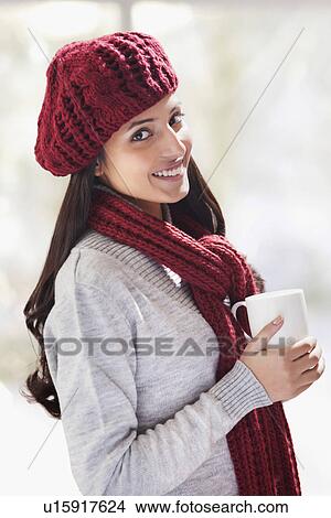 Picture - Portrait of young woman holding tea cup . Fotosearch