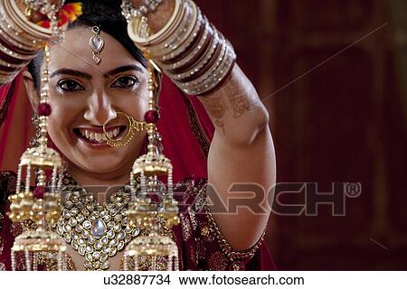 Portrait of young woman in traditional jewelry View Large Photo Image Picture - Portrait of young woman in traditional jewelry . Fotosearch