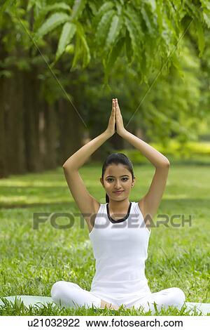 Stock Image - Portrait of young woman in yoga position . Fotosearch