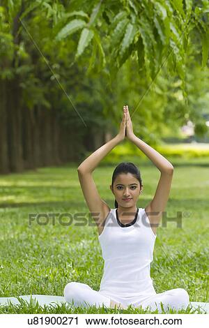 Portrait of young woman in yoga position View Large Photo Image Stock Image - Portrait of young woman in yoga position . Fotosearch