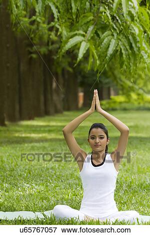 Stock Photo - Portrait of young woman in yoga position . Fotosearch