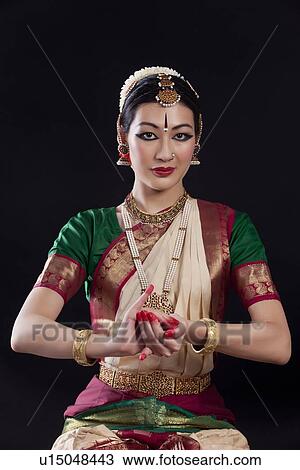 Portrait of young woman making Bharatanatyam gesture called Samputa on black background View Large Photo Image Stock Image - Portrait of young woman making Bharatanatyam gesture called Samputa on black background. Fotosearch