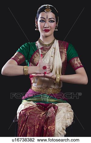 Portrait of young woman making Bharatanatyam gesture called Shivalingam on black background View Large Photo Image Stock Image - Portrait of young woman making Bharatanatyam gesture called Shivalingam on black background. Fotosearch