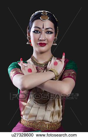 Portrait of young woman making Bharatanatyam gesture called Utsangam on black background View Large Photo Image Stock Image - Portrait of young woman making Bharatanatyam gesture called Utsangam on black background. Fotosearch
