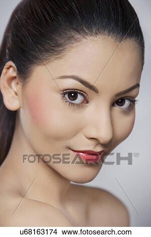 Portrait of young woman on grey background View Large Photo Image Picture - Portrait of young woman on grey background . Fotosearch