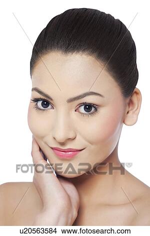 Portrait of young woman touching her face View Large Photo Image Picture - Portrait of young woman touching her face . Fotosearch