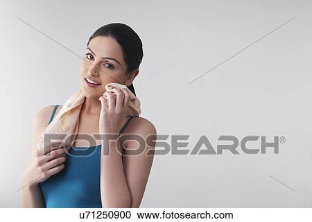 Portrait of young woman wiping her cheek with napkin isolated over gray background View Large Photo Image Stock Image - Portrait of young woman wiping her cheek with napkin isolated over gray background . Fotosearch