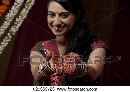 Stock Image - Portrait up of bride's hand with henna tattoo . Fotosearch