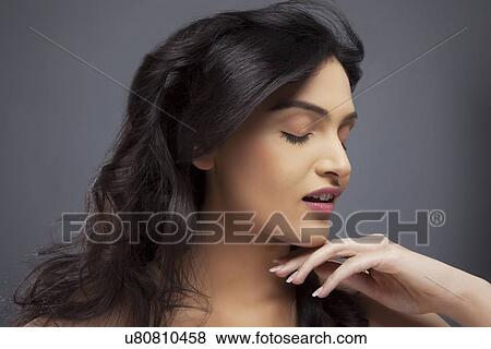 Pretty young female with eyes closed over colored background View Large Photo Image Stock Photo - Pretty young female with eyes closed over colored background . Fotosearch