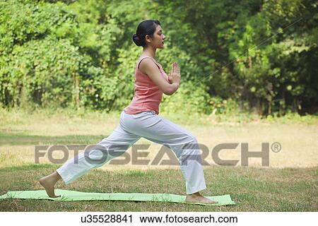 Stock Image - Pretty young woman practicing yoga . Fotosearch