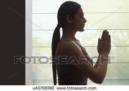 Profile shot of young woman meditating View Large Photo Image Stock Image - Profile shot of young woman meditating. Fotosearch