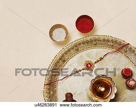 Rakhi and diya in a tray View Large Photo Image Stock Image - Rakhi and diya in a tray . Fotosearch