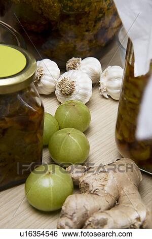 Stock Photograph - Raw garlic, ginger and gooseberry . Fotosearch