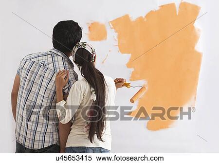 Rear view of couple looking at paint sample on the wall View Large Photo Image Stock Photography - Rear view of couple looking at paint sample on the wall . Fotosearch