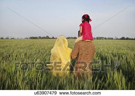 Rear view of rural family in an open field View Large Photo Image Stock Photo - Rear view of rural family in an open field . Fotosearch