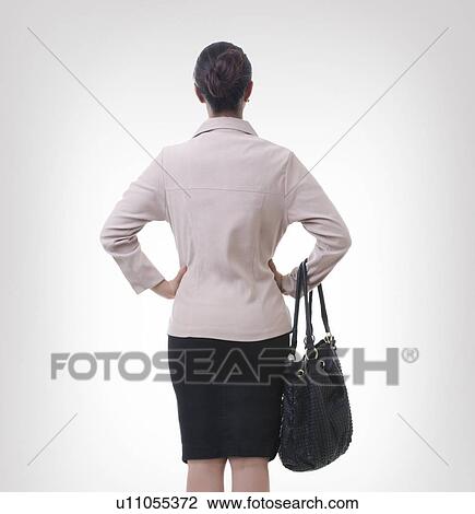 Rear view of well-dressed businesswoman over gray background View Large Photo Image Stock Image - Rear view of well-dressed businesswoman over gray background. Fotosearch