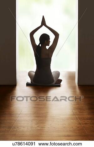 Rear view of woman meditating on floor View Large Photo Image Stock Image - Rear view of woman meditating on floor. Fotosearch