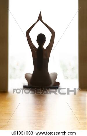 Rear view of young woman meditating on floor View Large Photo Image Stock Image - Rear view of young woman meditating on floor. Fotosearch