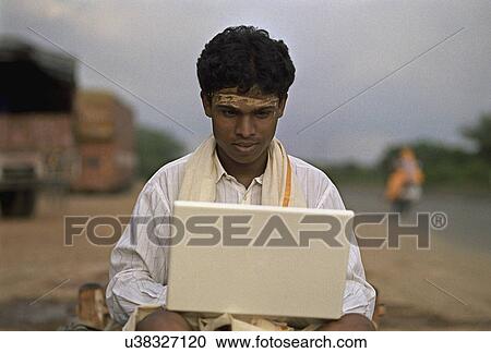 Stock Image - Rural man using a laptop . Fotosearch