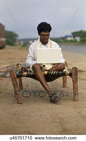 Rural man using a laptop View Large Photo Image Stock Image - Rural man using a laptop . Fotosearch