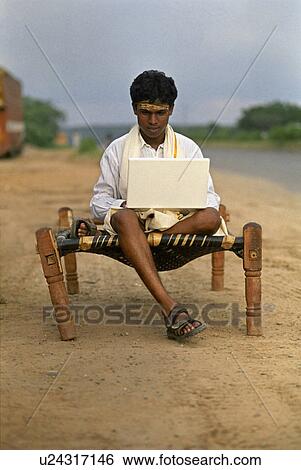 Rural man using a laptop View Large Photo Image Stock Photograph - Rural man using a laptop . Fotosearch