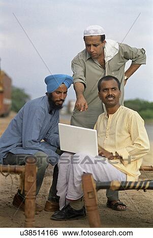 Rural man using a laptop View Large Photo Image Stock Photograph - Rural man using a laptop . Fotosearch