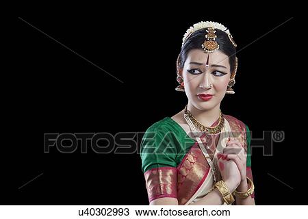 Sad dancer performing Bharatanatyam over black background View Large Photo Image Stock Image - Sad dancer performing Bharatanatyam over black background. Fotosearch