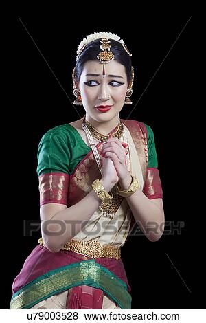 Stock Photo - Scared Bharatanatyam dancer performing on black background. Fotosearch