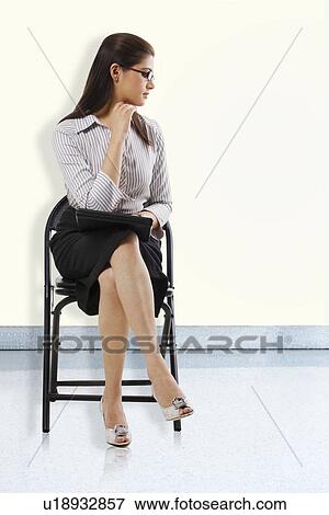 Stock Photo - Secretary sitting on a chair . Fotosearch
