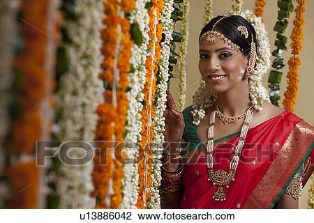 Selective focus of bride standing by garlands View Large Photo Image Stock Image - Selective focus of bride standing by garlands . Fotosearch