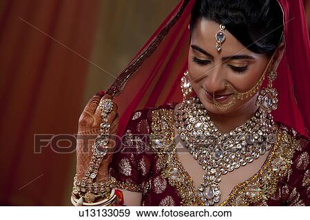Shy woman in traditional dress smiling View Large Photo Image Stock Photo - Shy woman in traditional dress smiling . Fotosearch