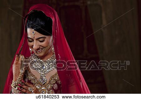 Stock Image - Shy young woman smiling . Fotosearch