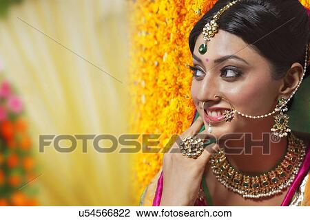 Stock Image - Side profile of a beautiful bride smiling. Fotosearch