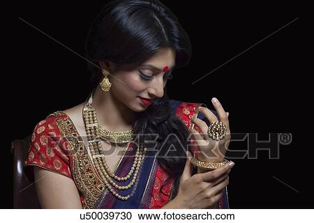 Stock Image - Side profile of a beautiful bride with jewelery. Fotosearch