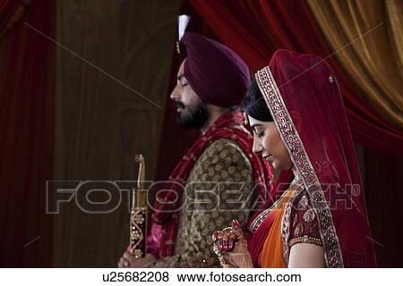 Stock Photo - Side view of couple with eyes closed on their wedding day . Fotosearch