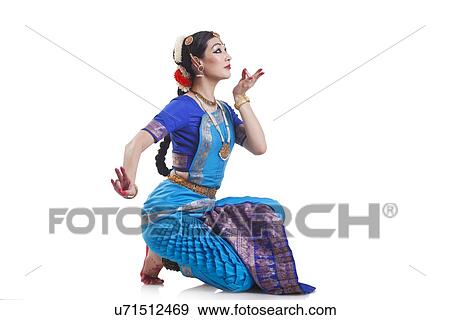 Stock Photo - Side view of dancer performing Bharatanatyam against white background. Fotosearch