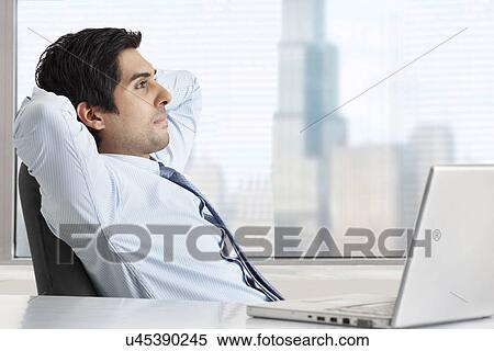 Side view of thoughtful businessman relaxing at his desk View Large Photo Image Stock Photography - Side view of thoughtful businessman relaxing at his desk . Fotosearch