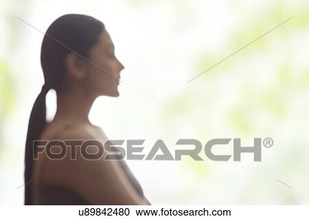 Side view of young woman meditating View Large Photo Image Stock Image - Side view of young woman meditating. Fotosearch