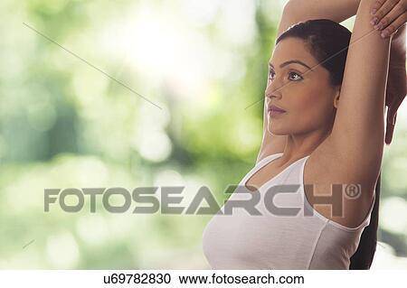 Side view of young woman stretching against glass View Large Photo Image Stock Image - Side view of young woman stretching against glass. Fotosearch