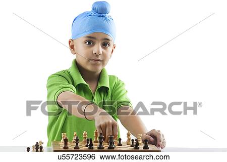 Stock Photograph - Sikh boy playing chess . Fotosearch