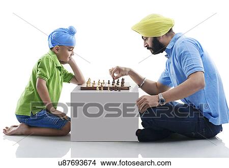 Sikh boy playing chess with his dad View Large Photo Image Picture - Sikh boy playing chess with his dad . Fotosearch