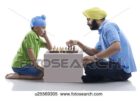 Sikh boy playing chess with his dad View Large Photo Image Stock Photography - Sikh boy playing chess with his dad . Fotosearch